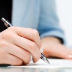 Businesswoman signing the contract.